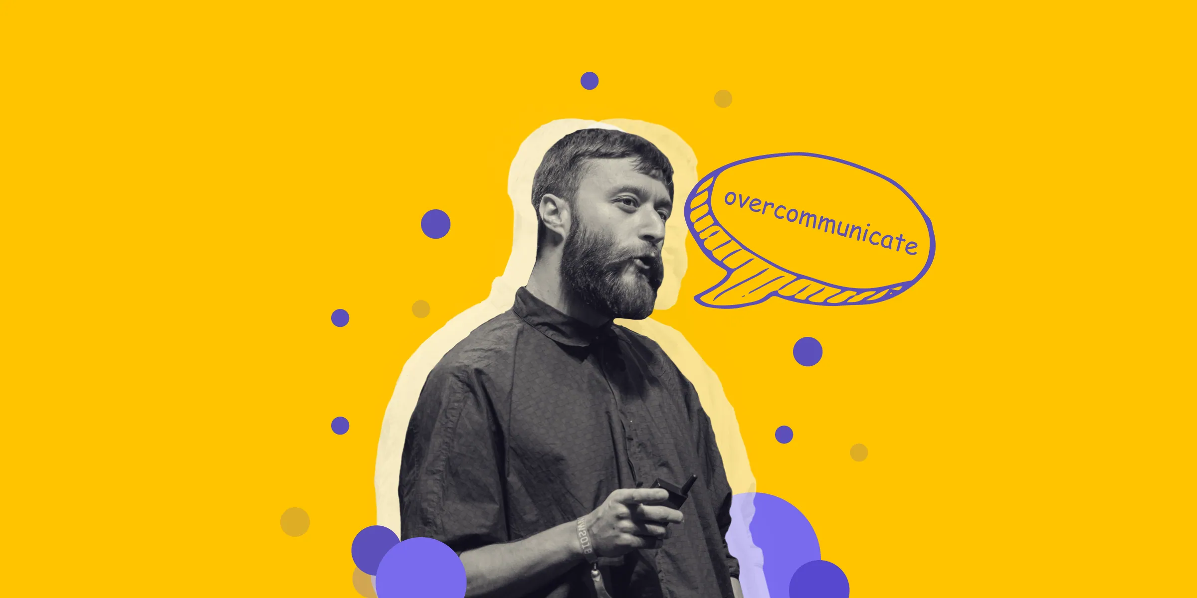 A speaker gesturing mid-sentence next to a hand-drawn speech bubble reading “overcommunicate”, on yellow