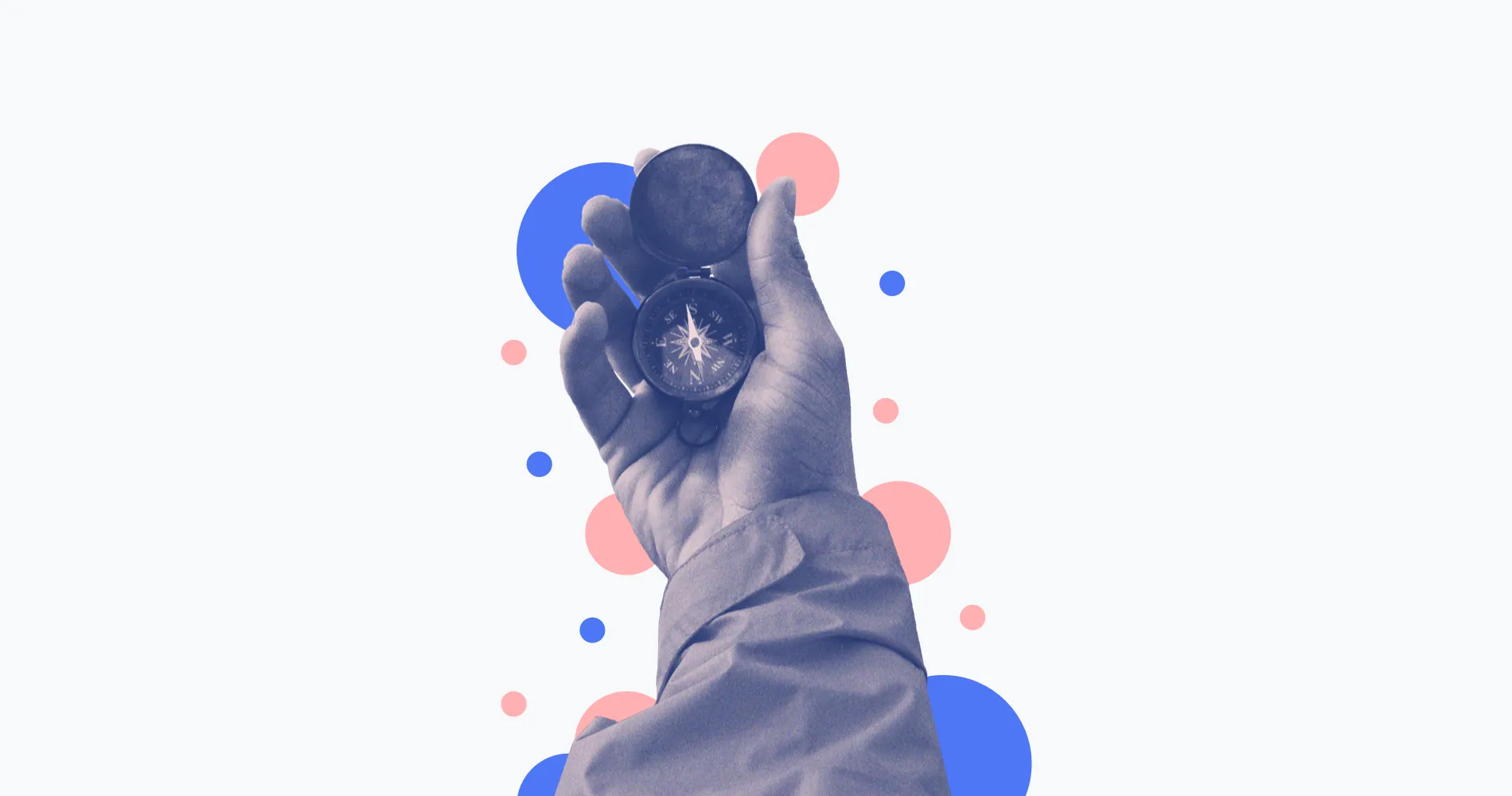 A hand holding a compass, in a cut-out collage with blue and pink dots