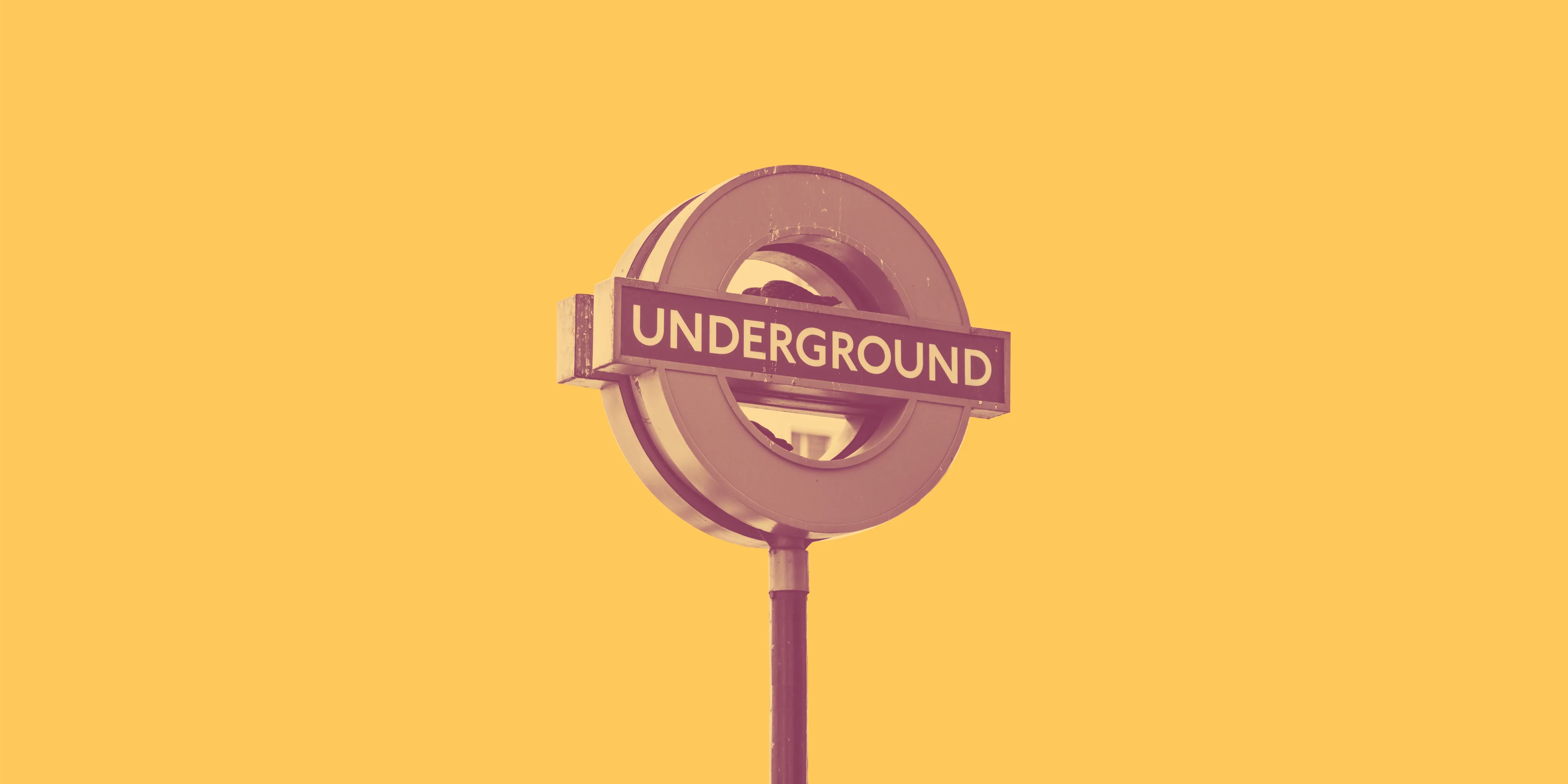 A London Underground roundel sign on a yellow background