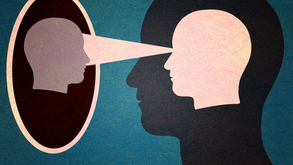 Two profile heads, a beam of light from one eye reaching into the other’s head, in pink and teal