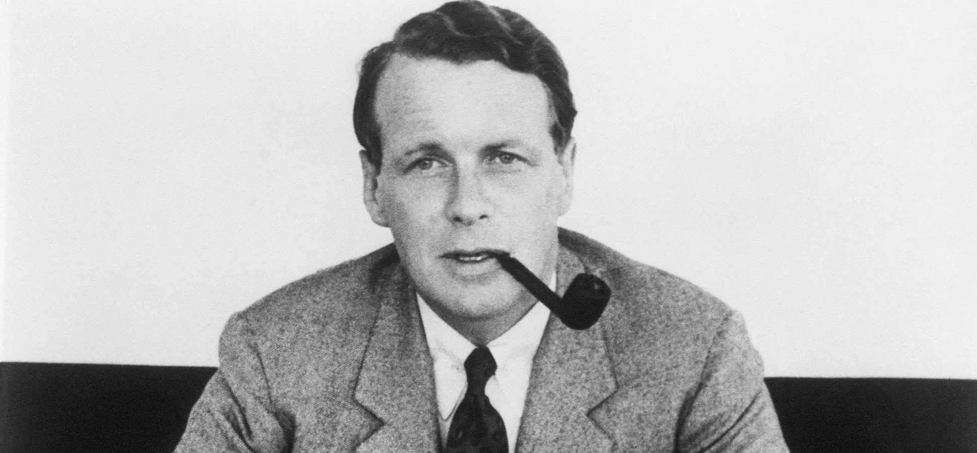 David Ogilvy, a black-and-white portrait with a pipe