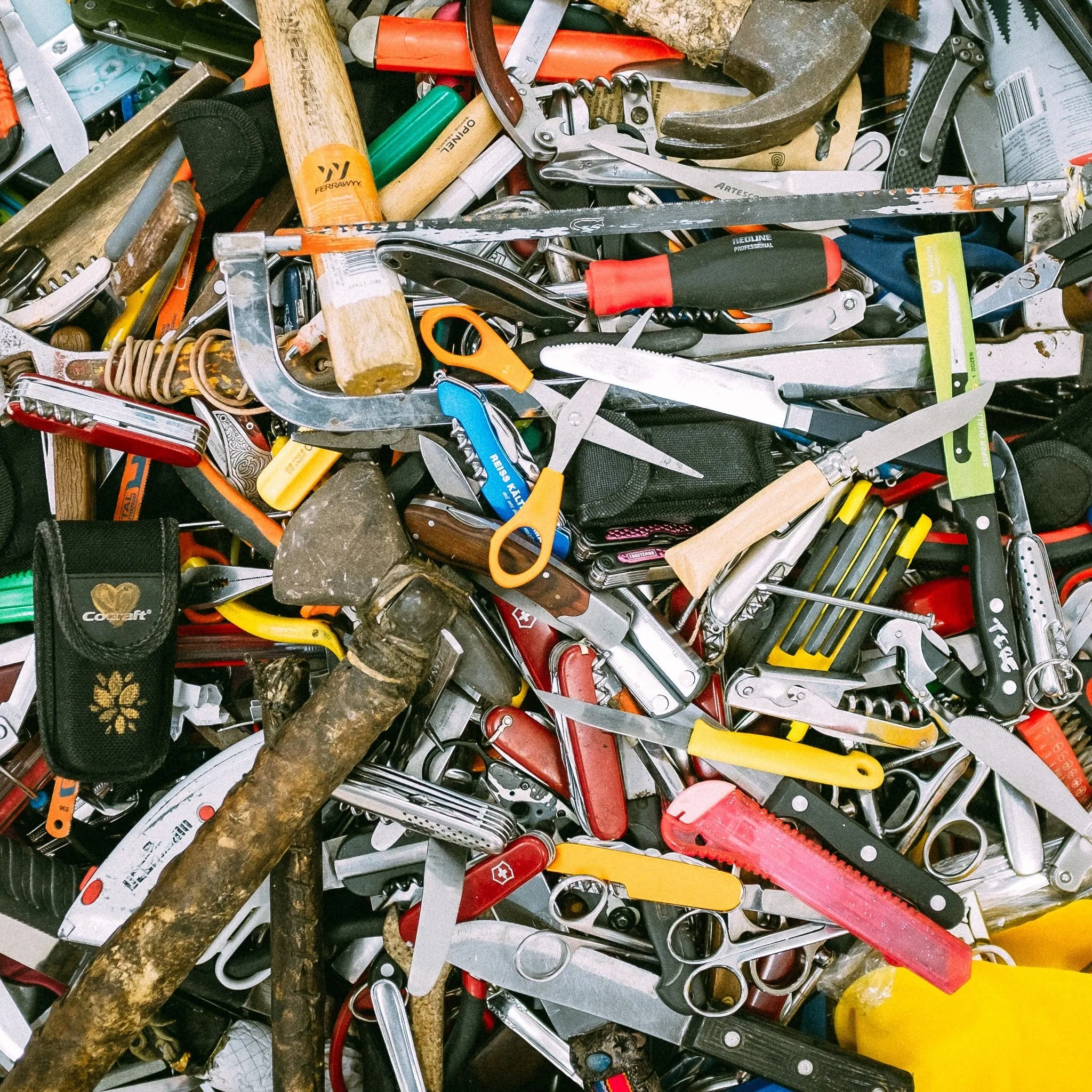 A heap of old tools: pliers, knives, scissors, screwdrivers and spanners
