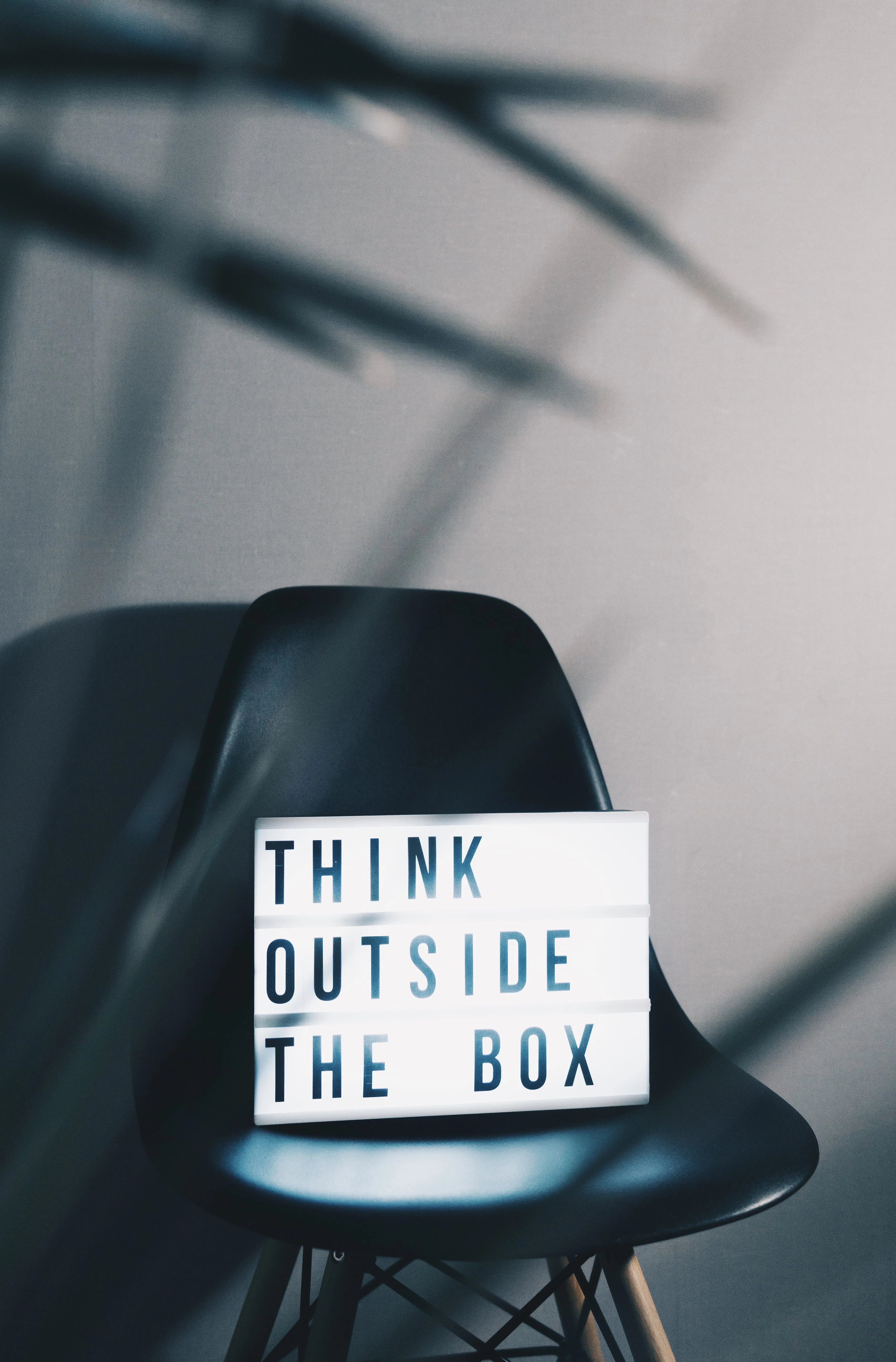 A light box on a chair reading Think Outside The Box